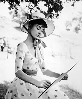 Prints of Portrait of Belgian-born American actress Audrey Hepburn (1929 - 1993) as she wears a bonnet and sketches on the set of War and Peace directed by King Vidor, 1956 Elegance Personified – A Classic Art Print Collection: Portrait Of Audrey Hepburn