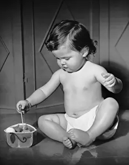 Portrait of baby playing w / toys