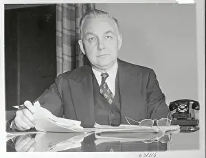 Portrait of Byron Price Sitting at His Desk