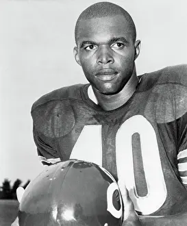 Prints of (Original Caption). Picture shows Chicago Bears pro-football halfback, Gale Sayers, posing in his uniform holding his helmet. Undated photo Gridiron Glory: Portrait Of Chicago Bears Gale Sayers
