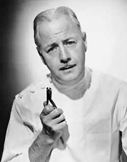 Portrait of dentist with medical instrument