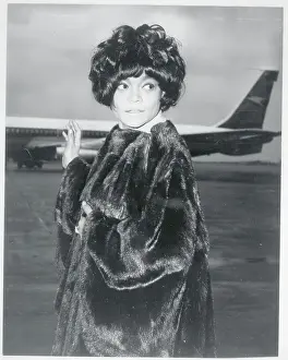 Prints of (Original Caption). Eartha Kitt arrives at London Airport for a flight to Los Angeles for a visit with her nine-year-old daughter Kitt. She was worried about her daughter after the recent earthquakes Captivating Art Prints Celebrating the Iconic Performer’s Legacy: Portrait of Eartha Kitt