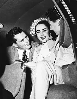 Prints of Elizabeth Taylor with her first husband, Nicky Hilton A Visual Odyssey Through Glamour and Stardom: Portrait of Elizabeth Taylor in Car with First Husband Nicky Hilton and Friend