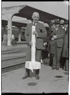 Portrait of Explorer Roald Amundsen Posing with Model Pole