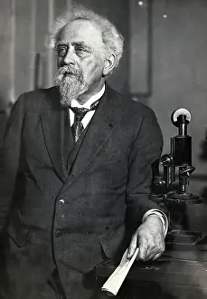 Chemistry Prints: Portrait of French Physicist Jean Baptiste Perrin Posing by Microscope