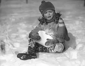 Warm Clothing Prints: Portrait of girl (6-7) playing in snow