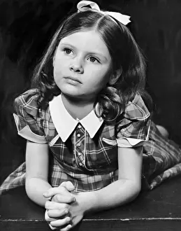 Portrait of girl with hands clasped together