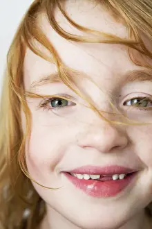 Tooth Prints: Portrait of a girl with red hair with a missing tooth