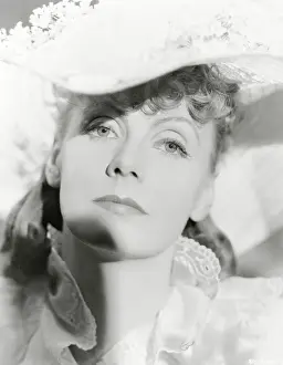 Prints of (Original Caption). Closeup of Greta Garbo in hat trimmed with small flowers. Movie still Timeless Elegance: The Iconic Greta Garbo Collection: Portrait of Greta Garbo
