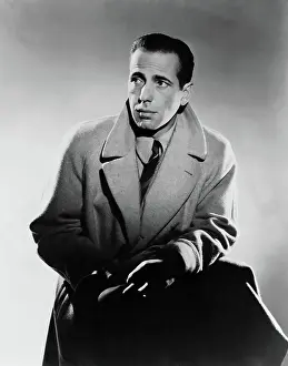 Prints of Publicity handout of actor Humphrey Bogart wearing his coat collar raised, 3/4 length, ca. 1930s The Essence of Cool: Portrait of Humphrey Bogart