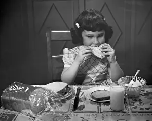 Portrait of little girl eating buttered toast
