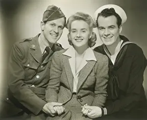 Portrait of mature woman with soldier and sailor, smiling