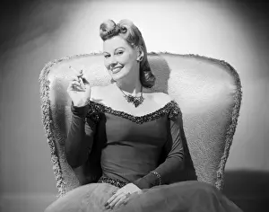 Portrait of mid adult woman sitting in armchair