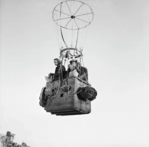 Prints of (Original Caption) Timeless Charm: A Visual Journey through the lens: Portrait of Paul Newman and Sophia Loren in Balloon