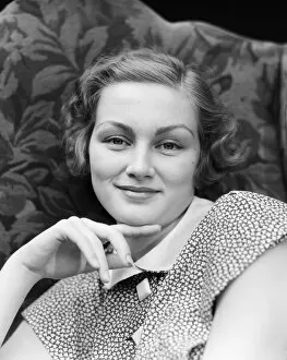 Portrait of smiling woman, chin resting on index finger