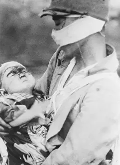 Portrait of Soldier Holding Burned Baby