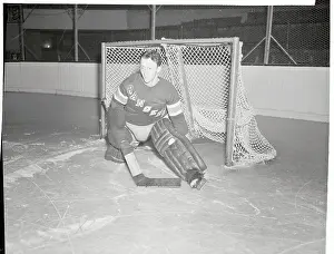 Prints of (Original Caption). Steve Buzinski, goal tender for the New York Rangers Hockey Club, takes time out from a Rangers practice session at Madison Square Garden to pose for his picture Frozen Moments: A Journey Through Hockey History: Portrait of Steve Buzinski