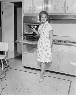 Portrait of woman cooking in kitchen