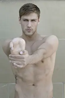 Reflective Prints: Portrait of a young bare-chested man, stretching his hand