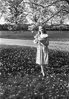 Easy Retouch Prints: Portrait of young woman standing under magnolia tree in park
