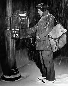 Postal Worker Picking Up Mail In Snow