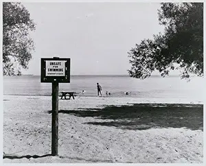 Posted Warning Sign at Sparsely Populated Beach Area