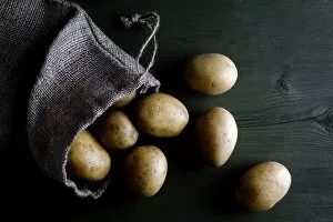 Images Dated 24th November 2012: Potatoes in burlap sack on wood