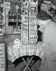 Berchtesgaden Prints: Potential Buyers Reading Postcard Display