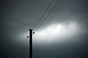 Power pole against a cloudy sky