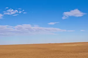 Prairie landscape under blue sky with white clouds, Omaha, Nebraska, USA
