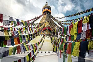 Business Finance And Industry Collection: Prayer flags with the Boudhanath Stupa in Kathmandu, Nepal