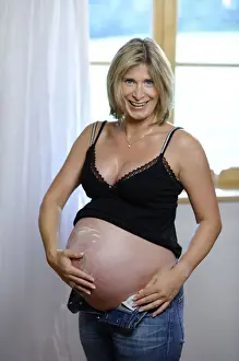 Enjoyment Prints: Pregnant woman applying lotion on her belly