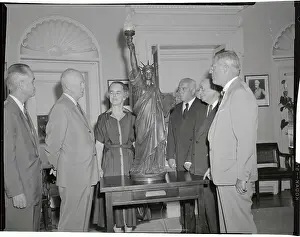 President Eisenhower Looking at a Model Statue of Liberty