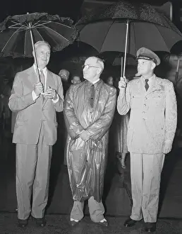 President Harry S. Truman Sharing Umbrellas with Undersecretary and General