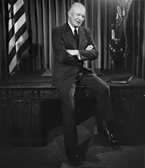 President Sits On Edge Of Desk