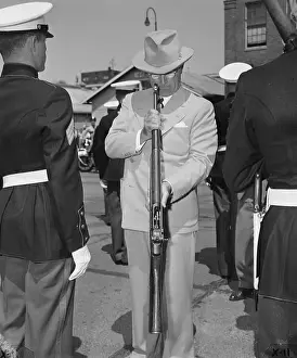 President Truman Looking Down the Barrel of Rifle