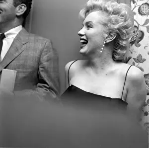Prints of LOS ANGELES - MARCH 3: Movie star Marilyn Monroe hosts a press party held at her home on March 3, 1956 in Los Angeles, California. (Photo by Earl Leaf/Michael Ochs Archives/Getty Images) Marilyn Monroe: The Iconic Muse Prints: Press Party At Marilyn's