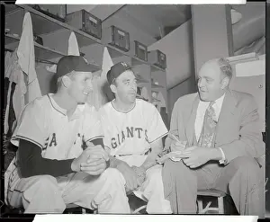 Press Reporter Taking Notes from Baseball Players in Locker Room