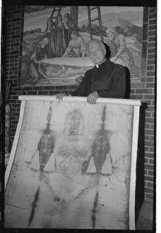 Priest Holding Replica of Shroud of Turin