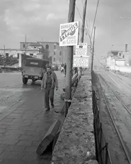 Private Prints: Private Walking Past Typhus Warning Sign on Street