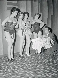 Producer Holding Clothes for Stripteasers