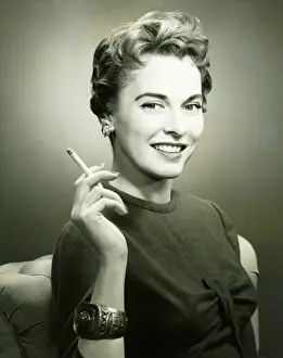 Smoking Activity Prints: Profile of smiling woman holding cigarette, (B&W), portrait
