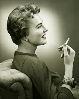 Cigarette Prints: Profile of smiling woman holding cigarette, (B&W), portrait