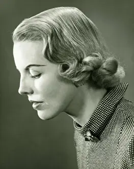 Profile of woman posing in studio, (B&W), portrait