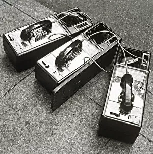 Public phones lying on sidewalk