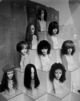 Retail Gallery: Pyramid shaped display of mannequin heads with wigs