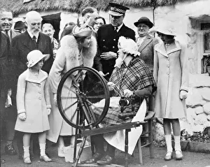 Prints of (Original Caption). Queen, Princesses at Empire Exposition Unveiling Her Majesty: Queen Elizabeth and Daughters Watching Woman at Spinning Wheel