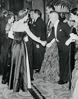 Prints of (Original Caption). The Queen Greets Chaplin Unveiling Her Majesty: Queen Elizabeth Shaking Hands with Charlie Chaplin