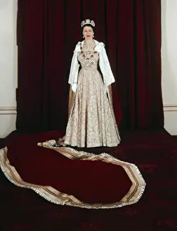 Prints of (Original Caption). Queen Elizabeth II of England is shown in full length formal attire Unveiling Her Majesty: Queen Elizabeth Wearing Long Gown and Jeweled Crown