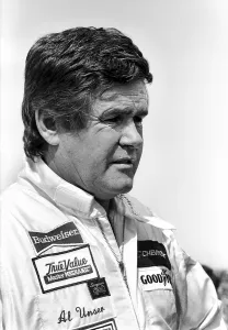 Prints of DAYTONA BEACH, FL - FEBRUARY 1986: Racecar driver Al Unser Sr. prepares to enter his car prior to the 1986 International Race of Champions at Daytona International Speedway in Daytona Beach, Florida Full Throttle At Daytona Beach Prints: Racecar driver Al Unser Sr